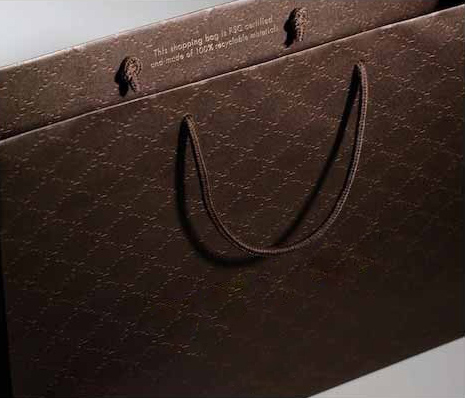 Close-up of a textured luxury paper bag with cord handles, showing premium carry finishing for retail and gifting packaging—Shabouk solutions in the UAE and GCC.